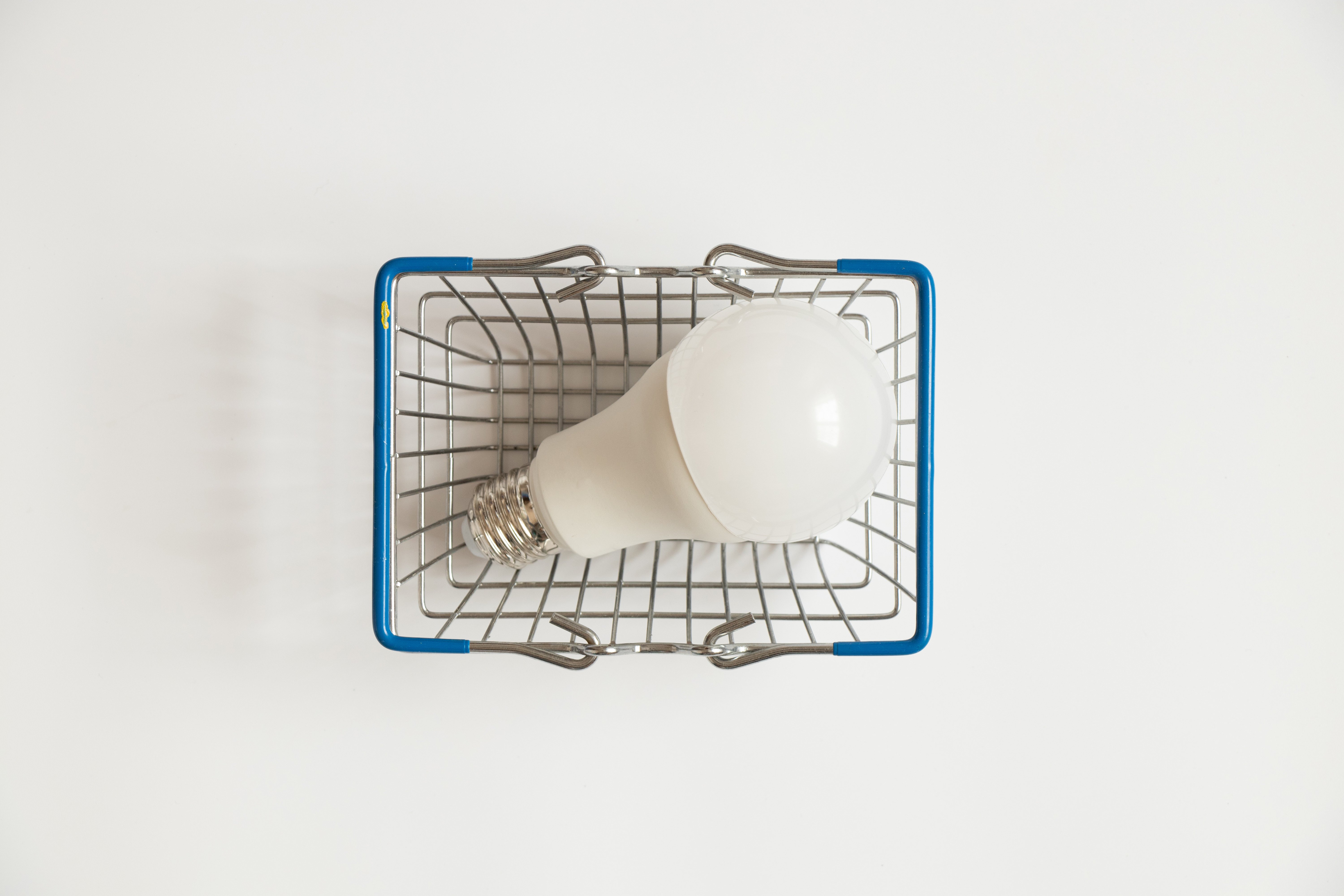 A shopping basket with a light bulb in it.