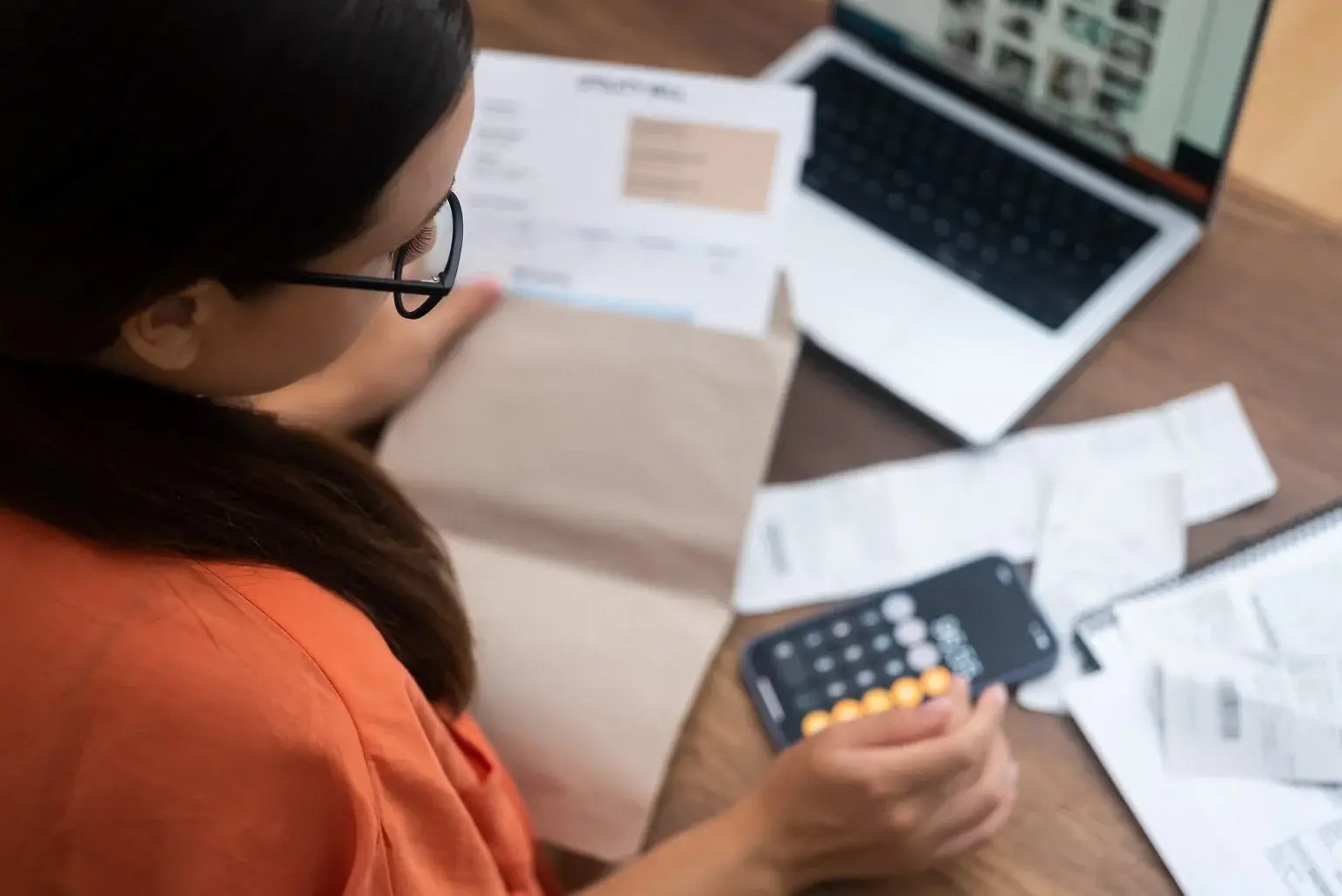 Business owner working out business costs  