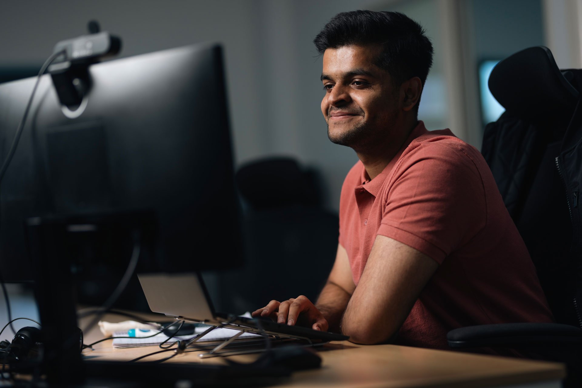 Man smiling at his desk