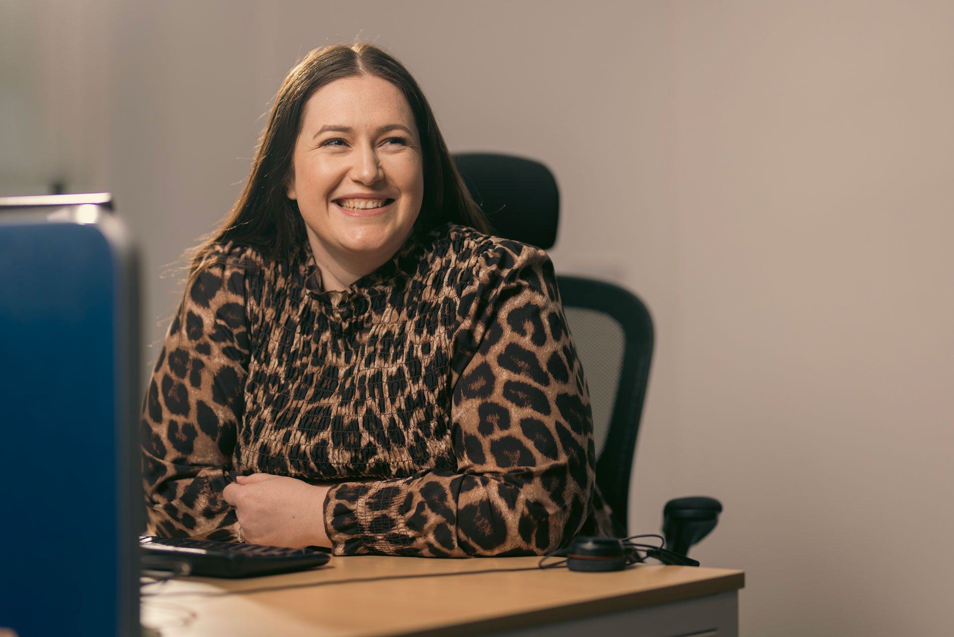 Woman smiling at her desk