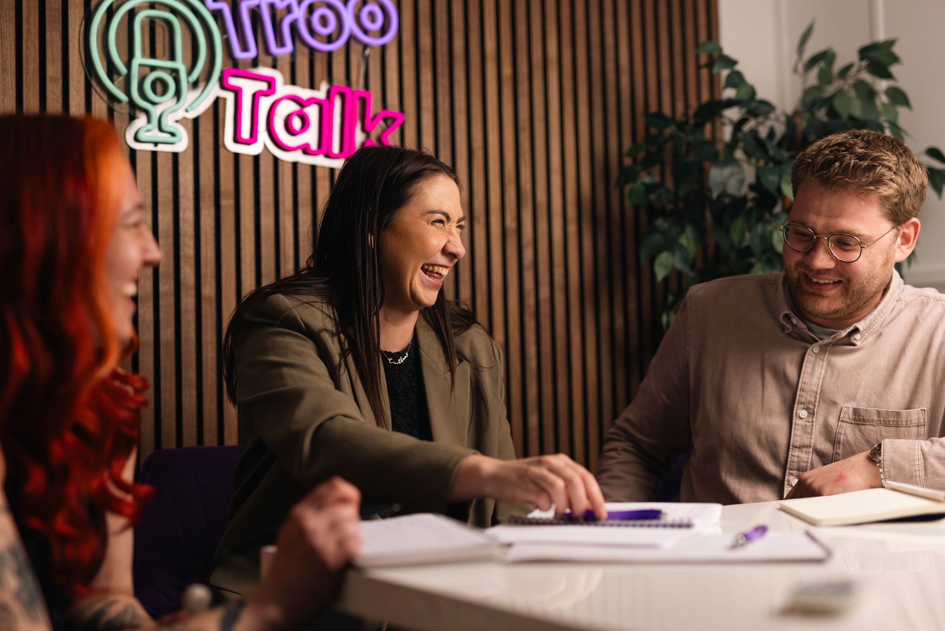 Three Troo Team members laughing during a meeting