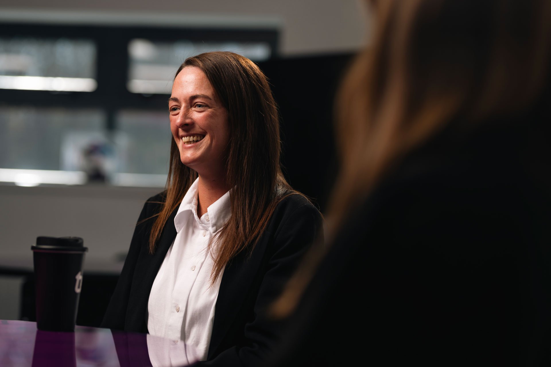 Woman smiling during a meeting