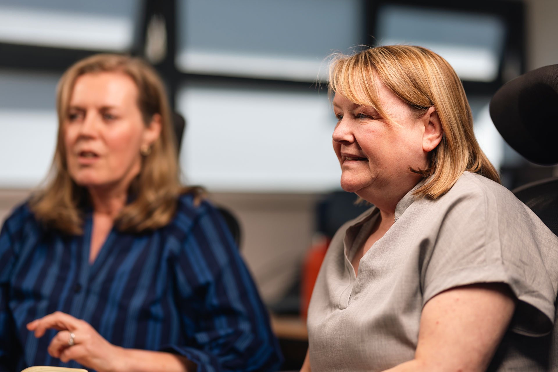Two women talking during a meeting