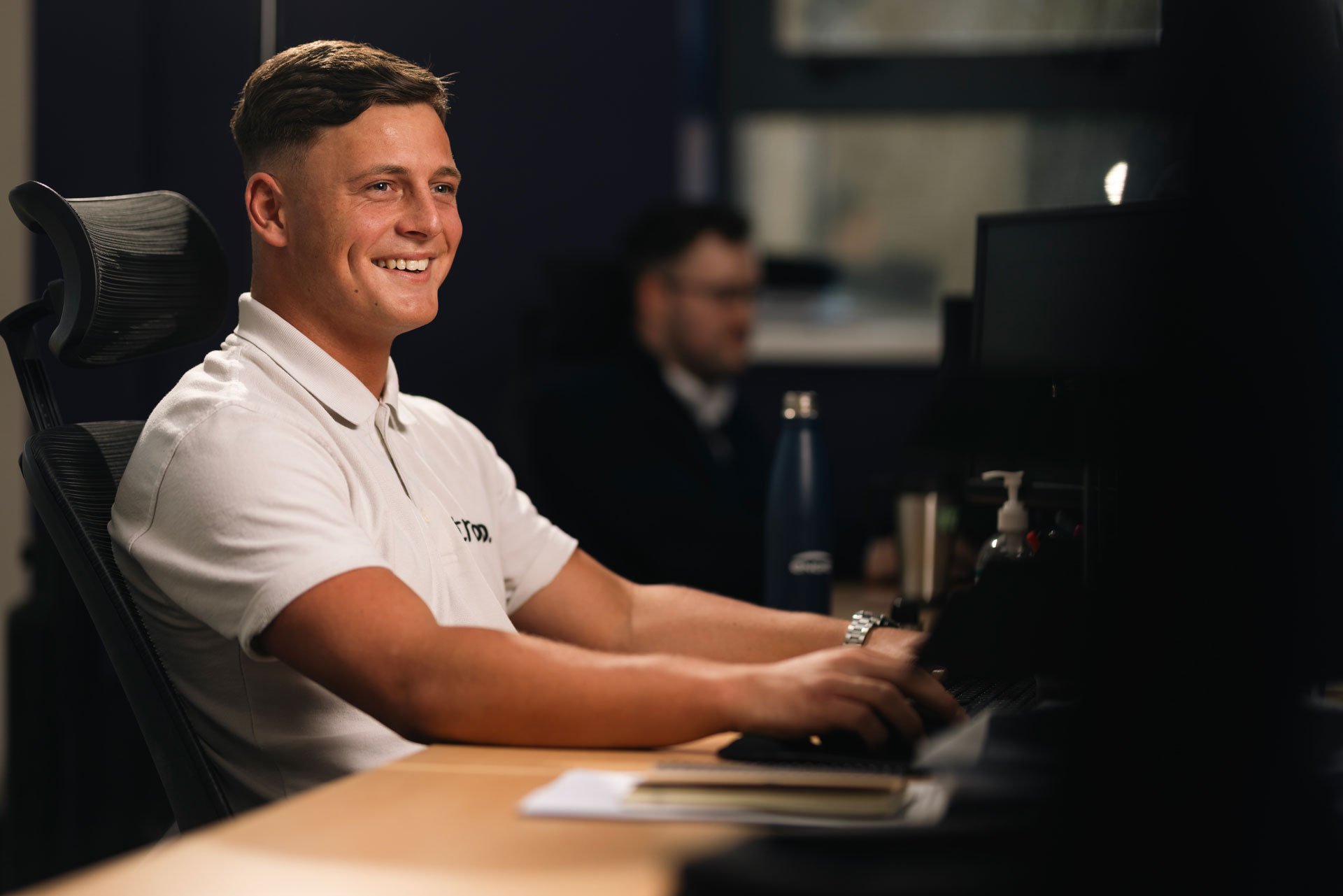 Man smiling at his desk