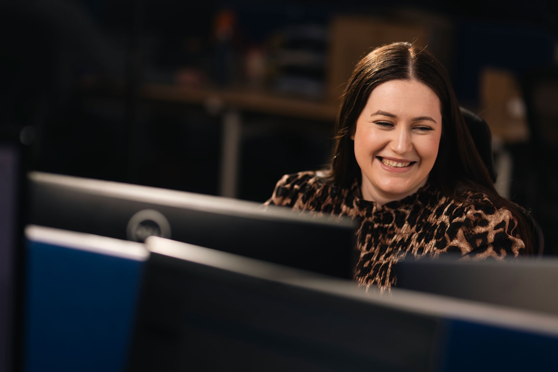 Woman smiling at her desk