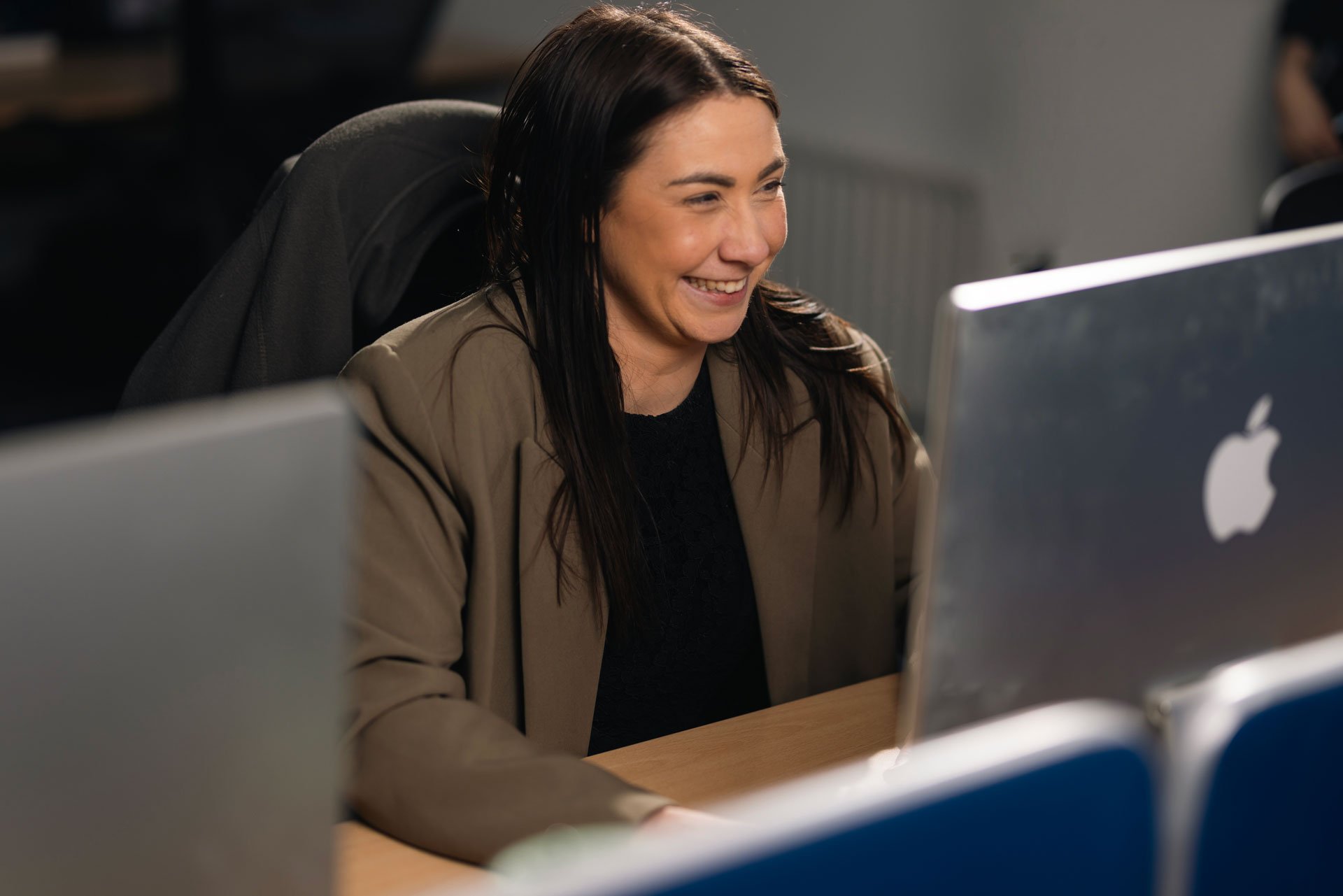 Woman smiling at her computer
