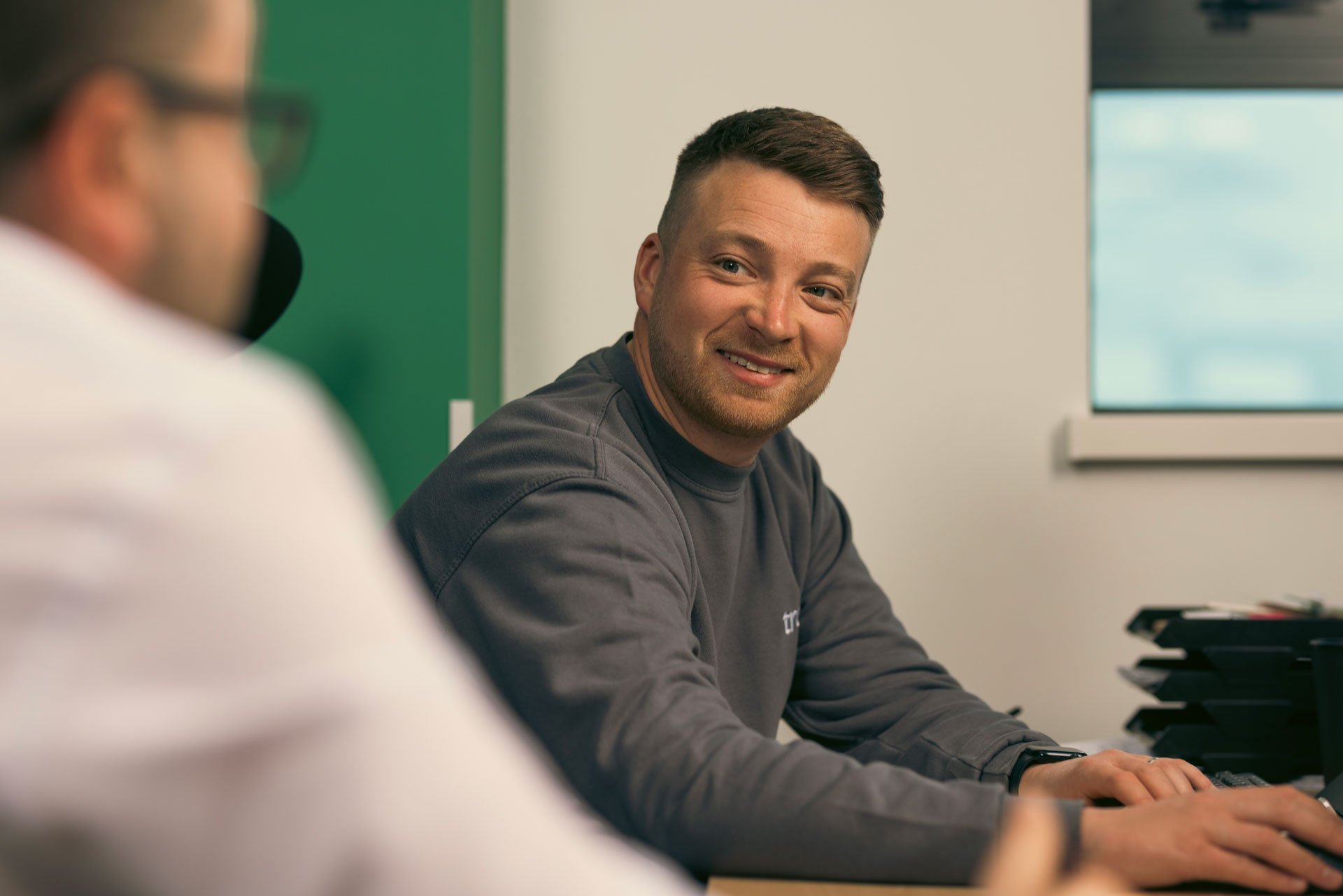 Man smiling at his colleague