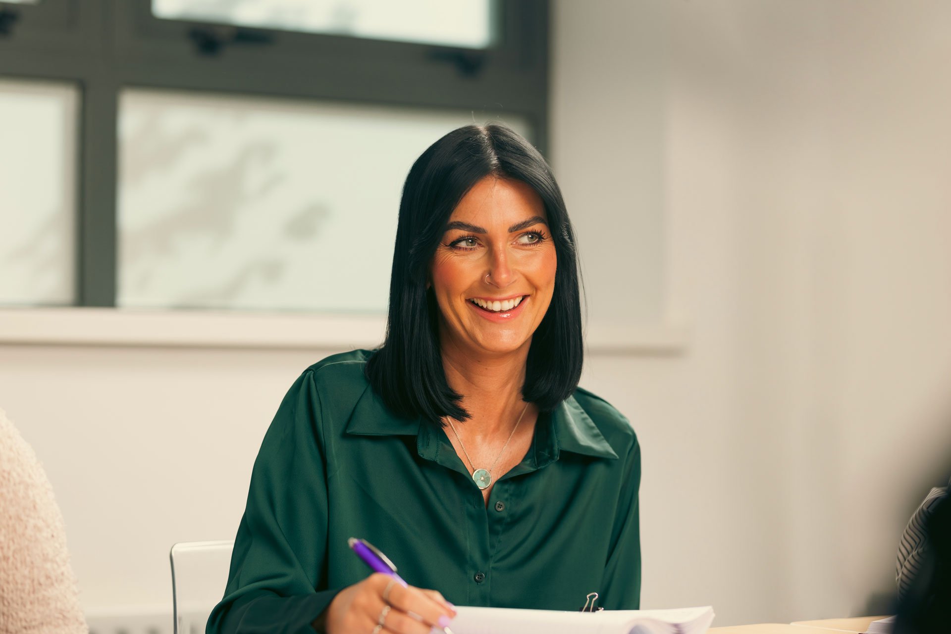 Woman smiling during a meeting